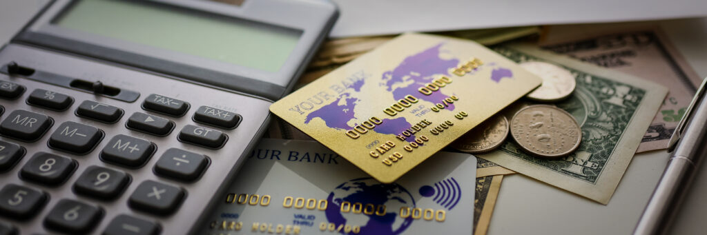 Big amount of US currency and calculator with financial document