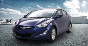 Blue Hyundai sitting on the road.
