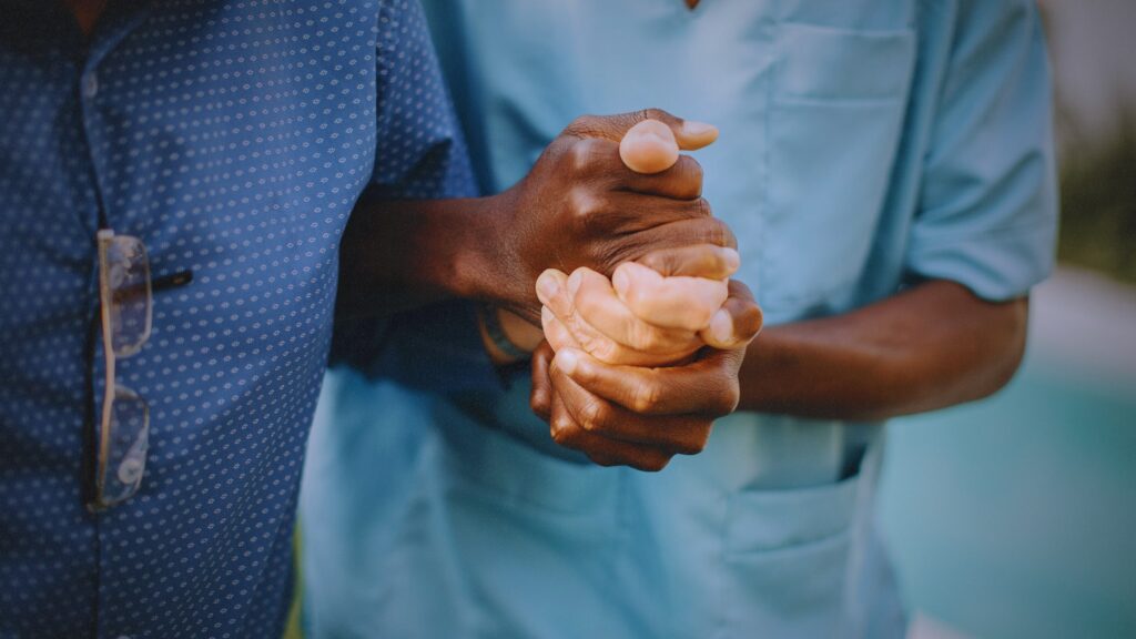 Irvine Nursing Home Abuse nurse holding hands with a patient.