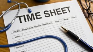 A paper that reads 'time sheet' sits on a desk with a stethoscope, pen, and glasses nearby.