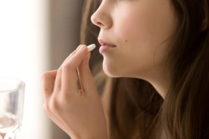 Woman taking pharmaceutical