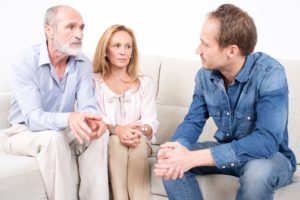 Man speaking with his concerned parents