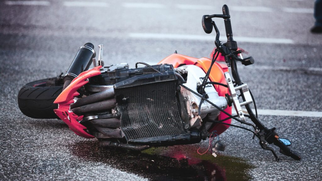 Motorcycle accident. Motorcycle down on pavement.