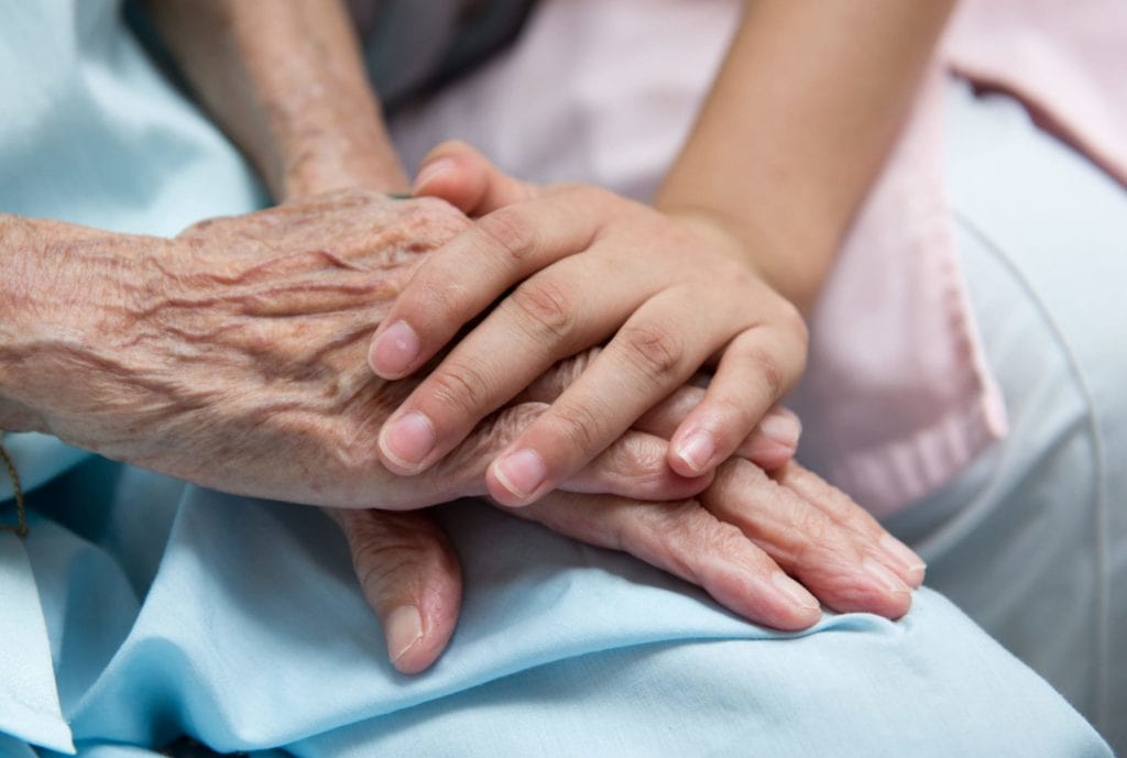 Nurse comforting Senior Citizen